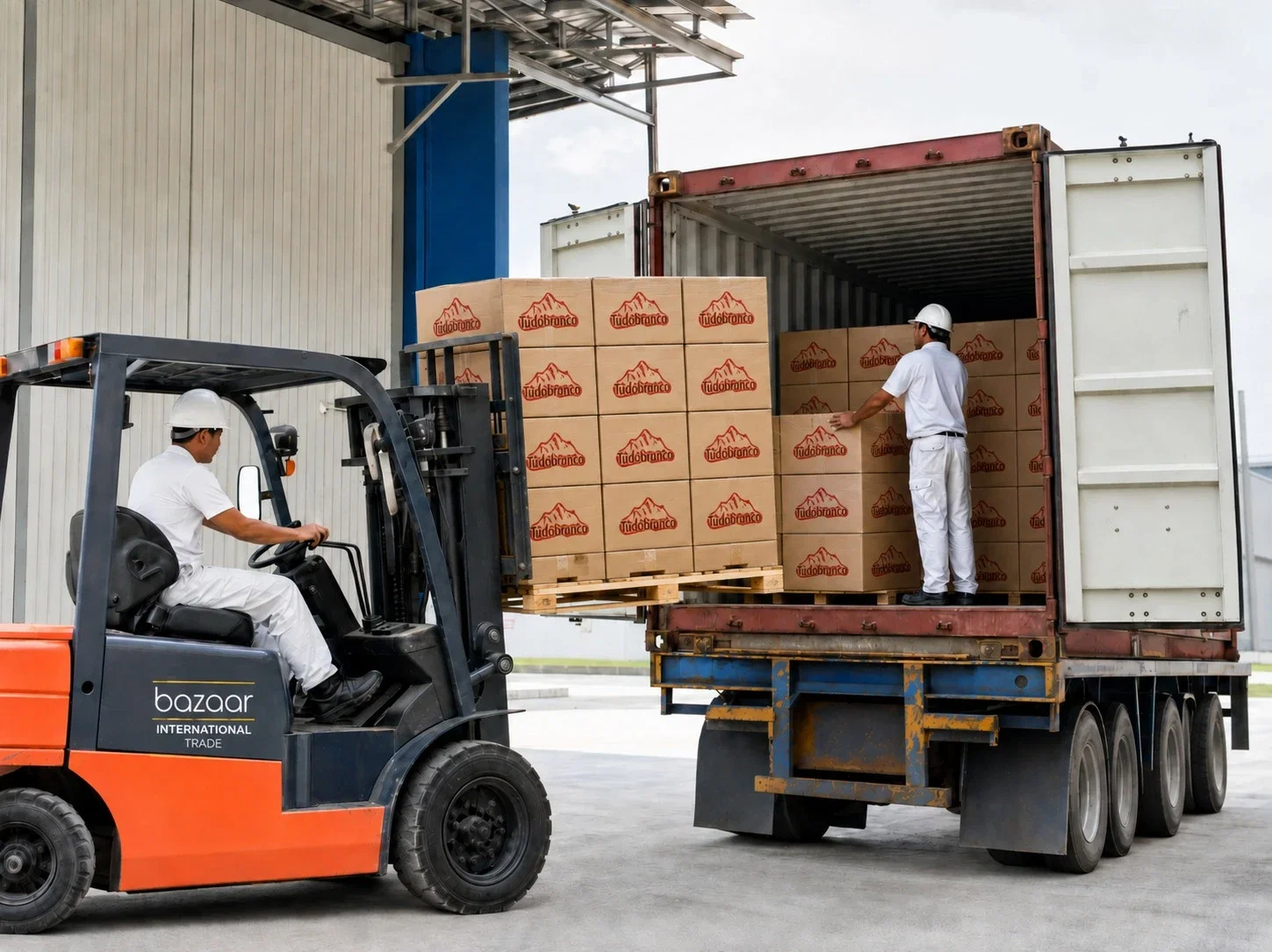 A forklift loading palletised cartons into a shipping container at the warehouse loading dock