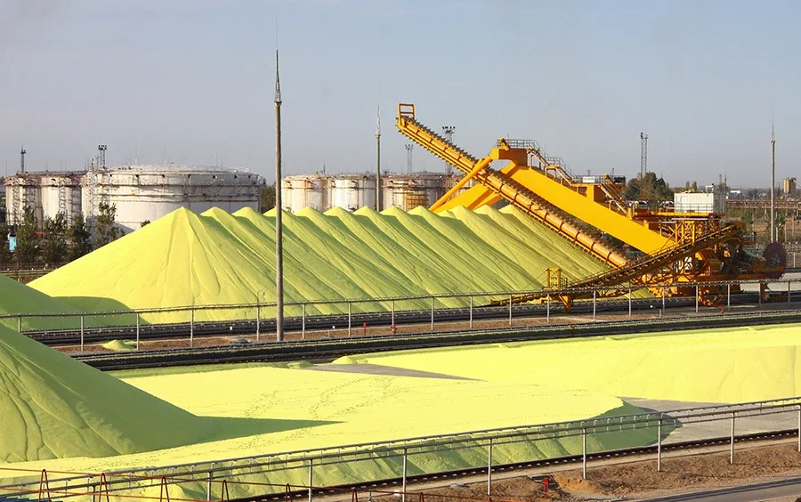 The source — sulfur blocks alongside a gas plant tank farm