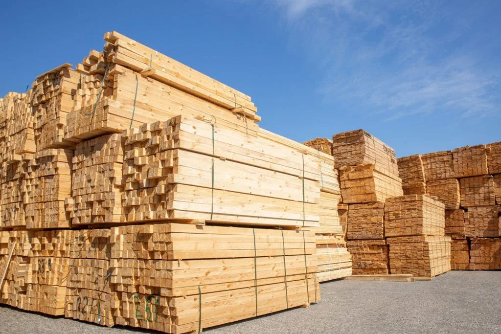 Sawn softwood in yard — the residue stream from timber processing is the primary feedstock for premium pellet production